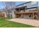 Backyard view of the raised deck, covered patio, basketball hoop, and mature trees at 6062 S Emporia Cir, Englewood, CO 80111