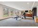 Bright basement featuring a workout area, entertainment space, and large windows at 6062 S Emporia Cir, Englewood, CO 80111