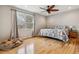 Bedroom with hardwood floors, natural light, and ceiling fan at 6062 S Emporia Cir, Englewood, CO 80111