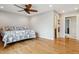 Spacious bedroom featuring hardwood floors and a ceiling fan at 6062 S Emporia Cir, Englewood, CO 80111