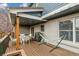 Spacious covered deck with seating, a grill, and views of the surrounding trees and yard at 6062 S Emporia Cir, Englewood, CO 80111