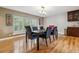 Dining room with hardwood floors, a large window, and a modern chandelier at 6062 S Emporia Cir, Englewood, CO 80111