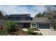 Charming exterior with solar panels, manicured landscaping, and a two-car garage at 6062 S Emporia Cir, Englewood, CO 80111