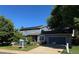 Charming two-story home with blue siding, a well-manicured front yard, and a welcoming driveway at 6062 S Emporia Cir, Englewood, CO 80111
