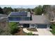 Aerial view of a charming two-story home featuring solar panels and an attached garage at 6062 S Emporia Cir, Englewood, CO 80111