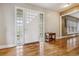 Bright foyer with hardwood floors and a unique glass block window at 6062 S Emporia Cir, Englewood, CO 80111