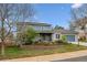 Charming two-story home featuring a well-manicured front yard and an attached garage at 6062 S Emporia Cir, Englewood, CO 80111