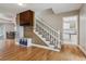 Hallway featuring hardwood floors, a staircase, and built-in storage at 6062 S Emporia Cir, Englewood, CO 80111