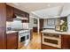 Stylish kitchen with stainless steel appliances, dark cabinets and wood floors at 6062 S Emporia Cir, Englewood, CO 80111