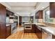 Modern kitchen features stainless steel appliances, wooden floor and cabinetry at 6062 S Emporia Cir, Englewood, CO 80111