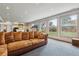 Bright living room with a plush sofa, large windows offering backyard views, and exercise equipment at 6062 S Emporia Cir, Englewood, CO 80111