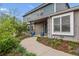 Inviting walkway leading to the front door of this charming home with beautiful landscaping at 6062 S Emporia Cir, Englewood, CO 80111