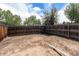 Large backyard with a wooden fence and potential for landscaping at 709 Arrow Ct, Lafayette, CO 80026