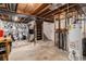 Unfinished basement with exposed beams, water heater, and ample storage space at 709 Arrow Ct, Lafayette, CO 80026