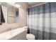 Bathroom featuring a single sink vanity and blue and white shower curtain at 709 Arrow Ct, Lafayette, CO 80026