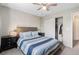 Bright bedroom featuring a ceiling fan, closet, and stylish decor at 709 Arrow Ct, Lafayette, CO 80026