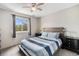 Bright bedroom featuring a ceiling fan, and a sunny window with blue skies at 709 Arrow Ct, Lafayette, CO 80026