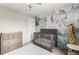 Charming Bedroom with jungle-themed wallpaper, a crib, and neutral colors at 709 Arrow Ct, Lafayette, CO 80026