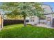 Exterior of home in backyard featuring a lawn and wood fencing at 544 N Logan St, Denver, CO 80203