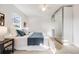 Well-lit bedroom with a queen bed, ceiling fan, and mirrored closet at 544 N Logan St, Denver, CO 80203