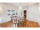 Inviting dining area with hardwood floors, modern table setting, and abundant natural light from large windows at 544 N Logan St, Denver, CO 80203