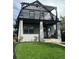 Charming two-story home features a striking pergola and a well-manicured front yard with lush green grass at 544 N Logan St, Denver, CO 80203