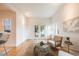 Bright living room featuring hardwood floors, neutral decor, and French doors leading to a lush outdoor space at 544 N Logan St, Denver, CO 80203