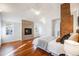 Spacious main bedroom featuring a decorative fireplace, hardwood floors, and ample natural light at 544 N Logan St, Denver, CO 80203