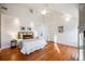 Bright main bedroom featuring hardwood floors, white walls, a ceiling fan, and neutral bedding at 544 N Logan St, Denver, CO 80203