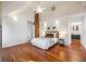 Spacious main bedroom featuring a decorative brick wall, hardwood floors, and ensuite bathroom at 544 N Logan St, Denver, CO 80203