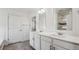 Modern bathroom featuring a double sink vanity and a large mirror at 1876 Chaffee Crest Dr, Berthoud, CO 80513