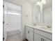 Bathroom featuring double vanity, quartz countertops, and view to the tub at 1876 Chaffee Crest Dr, Berthoud, CO 80513