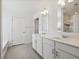 Bathroom with double vanity, quartz countertops and tile floor at 1876 Chaffee Crest Dr, Berthoud, CO 80513