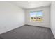 Bedroom featuring neutral decor, plush carpet, and neighborhood views at 1876 Chaffee Crest Dr, Berthoud, CO 80513