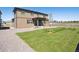 Two story home with a well-maintained lawn, stone landscaping, covered patio, and durable siding for lasting curb appeal at 1876 Chaffee Crest Dr, Berthoud, CO 80513