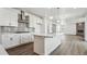 Modern kitchen with white cabinets, stainless steel appliances, and a center island at 1876 Chaffee Crest Dr, Berthoud, CO 80513