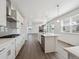 Bright and open kitchen with wood floors, stainless steel appliances, and an eat-in island at 1876 Chaffee Crest Dr, Berthoud, CO 80513
