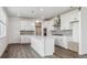 Bright kitchen featuring white cabinets, stainless steel appliances, and an island at 1876 Chaffee Crest Dr, Berthoud, CO 80513