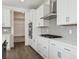 Bright kitchen with stainless steel appliances, white cabinets, and modern fixtures at 1876 Chaffee Crest Dr, Berthoud, CO 80513