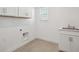 Bright laundry room with a window, a sink, and storage at 1876 Chaffee Crest Dr, Berthoud, CO 80513