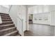 Staircase leading to the living room with a fireplace and large windows at 1876 Chaffee Crest Dr, Berthoud, CO 80513