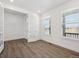 Bright office with wood floors, white trim, and natural light from the many windows at 1876 Chaffee Crest Dr, Berthoud, CO 80513