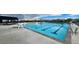 Large community pool featuring lap lanes, chairs, and shaded seating areas at 1876 Chaffee Crest Dr, Berthoud, CO 80513