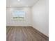 Bright room with wood floors, white trim, and natural light from the window at 1876 Chaffee Crest Dr, Berthoud, CO 80513
