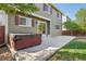 Exterior shot of a backyard featuring a hot tub and a large patio area with plenty of room at 418 Hayloft Way, Brighton, CO 80601