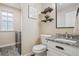 Charming half bath with stylish granite countertop and decor shelves near the laundry area at 418 Hayloft Way, Brighton, CO 80601