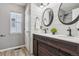 Charming bathroom featuring a dual sink vanity, shiplap wall, and modern fixtures at 418 Hayloft Way, Brighton, CO 80601