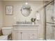Well-lit bathroom featuring a shower and a vanity with granite countertop and storage cabinets at 418 Hayloft Way, Brighton, CO 80601