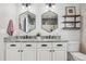 Chic bathroom with dual hexagon mirrors, granite counters, and stylish lighting at 418 Hayloft Way, Brighton, CO 80601
