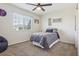 Comfortable bedroom with a twin bed, neutral decor, and a large window providing natural light and backyard views at 418 Hayloft Way, Brighton, CO 80601